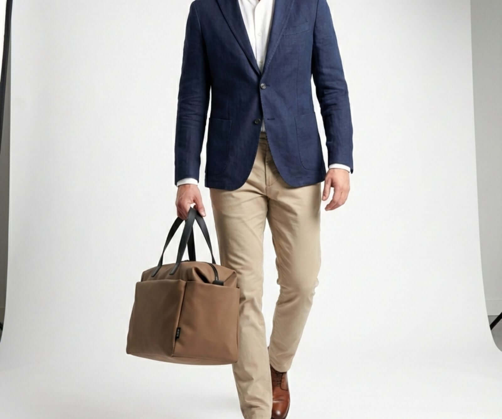 A person is holding Sahari and brown weekender